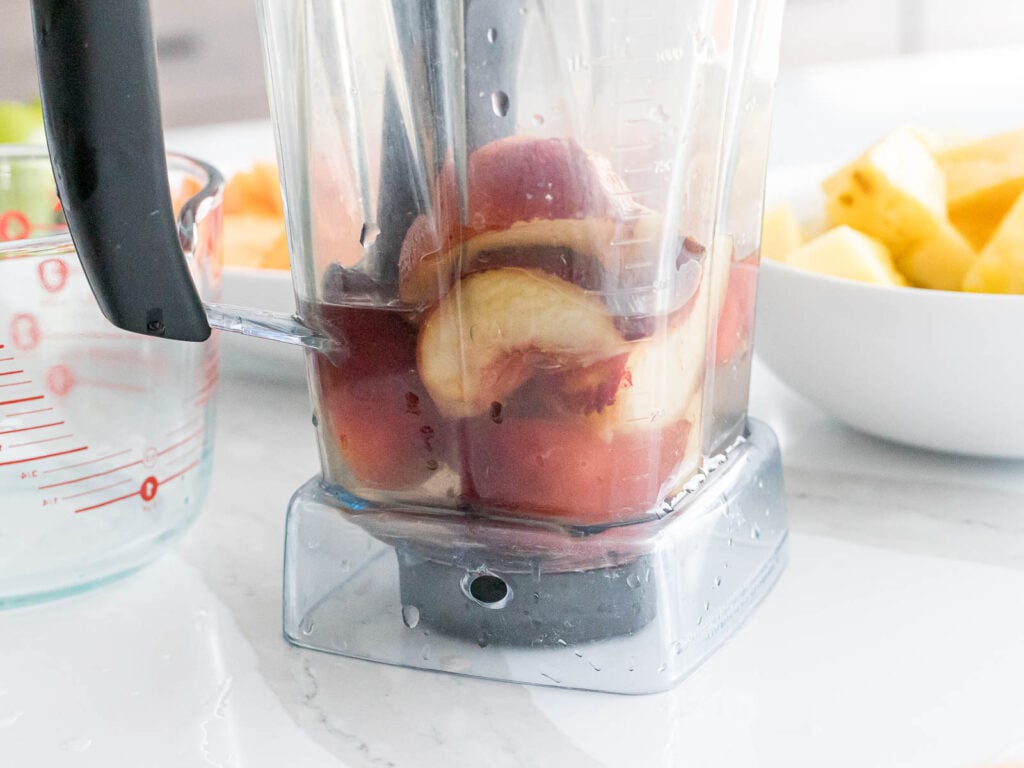 slices of white peach in a blender