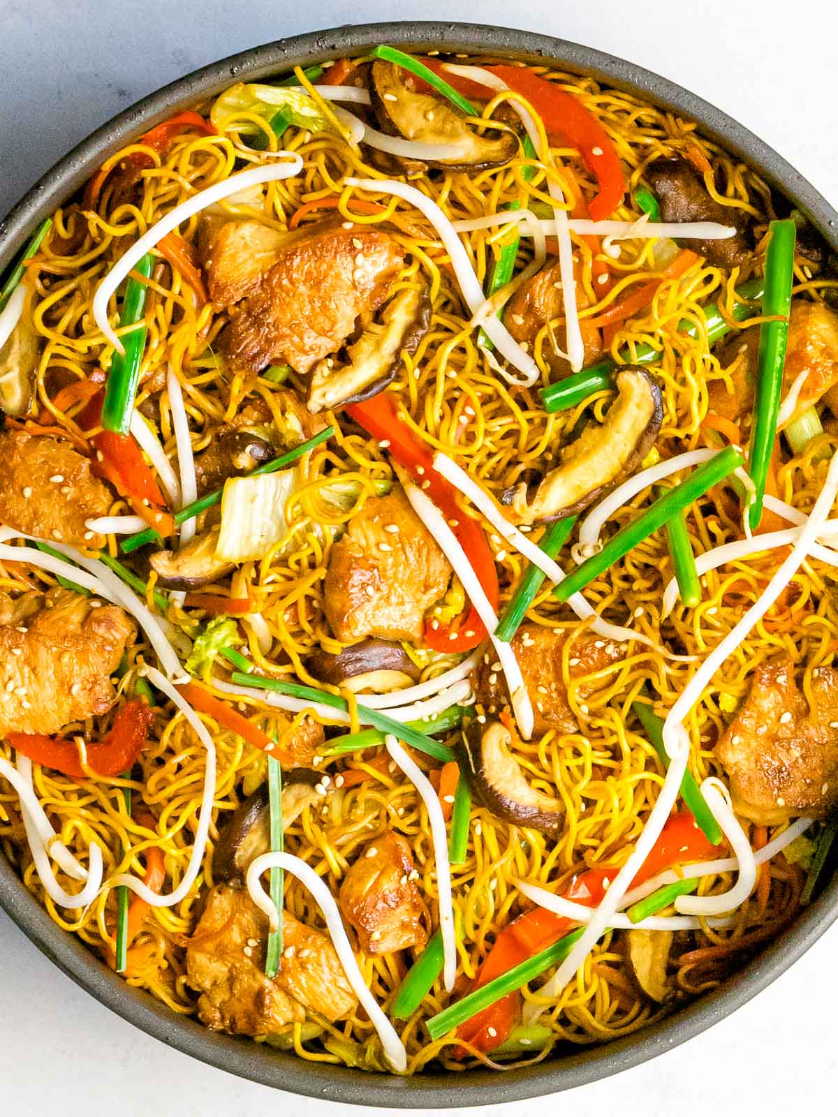 Chinese chow mein noodles with chicken and vegetables in a pan