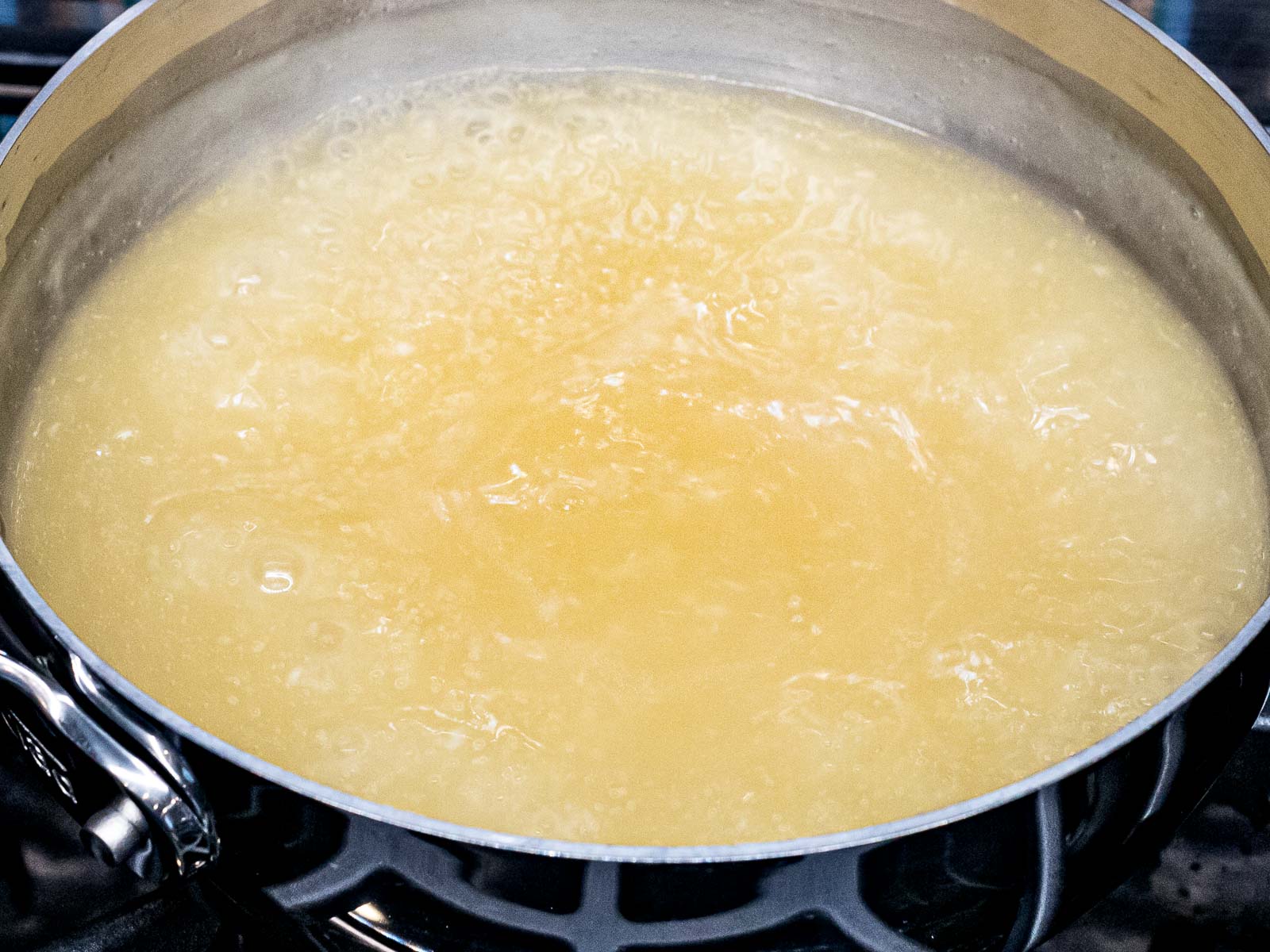 chicken stock boiling in a pot