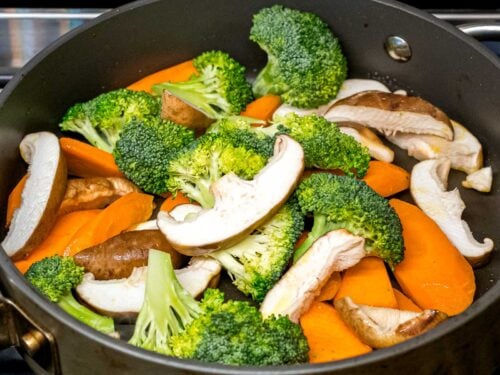 mushroom, broccoli, and carrots stir fried in a pan