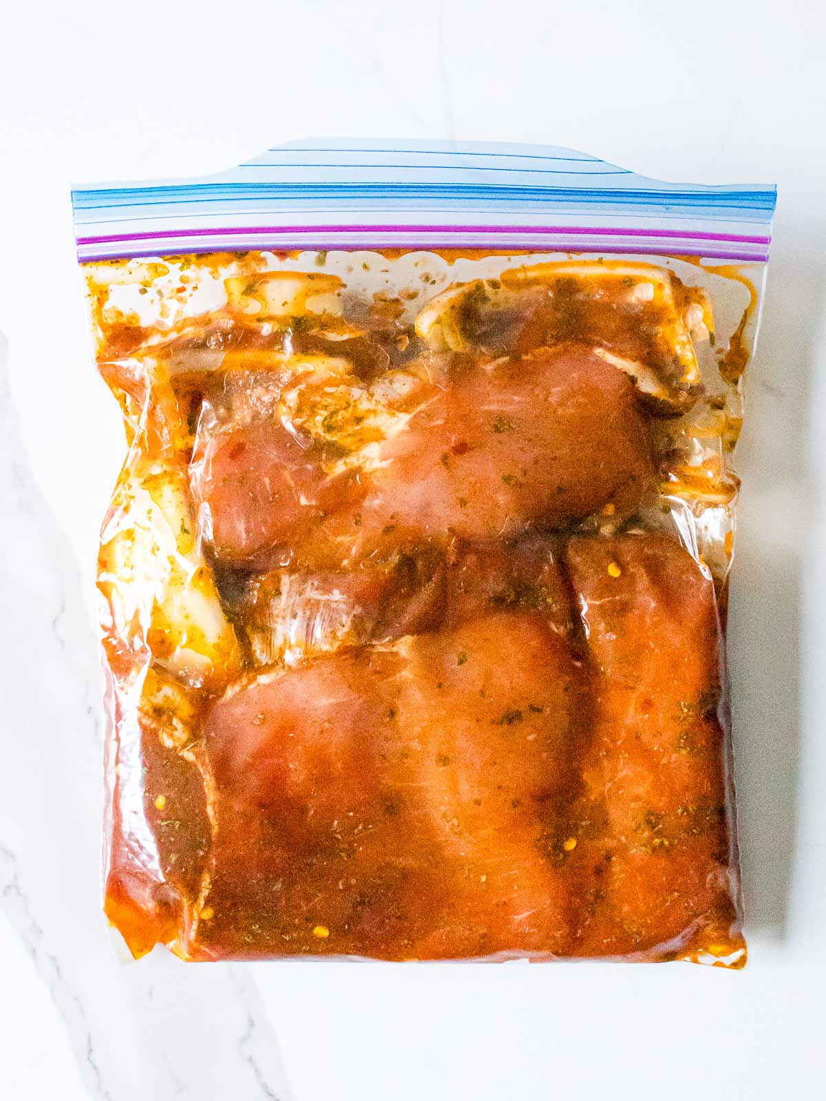 pork chops marinating in a ziplock bag