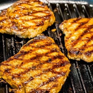 juicy grilled pork chops with grill marks in a pan