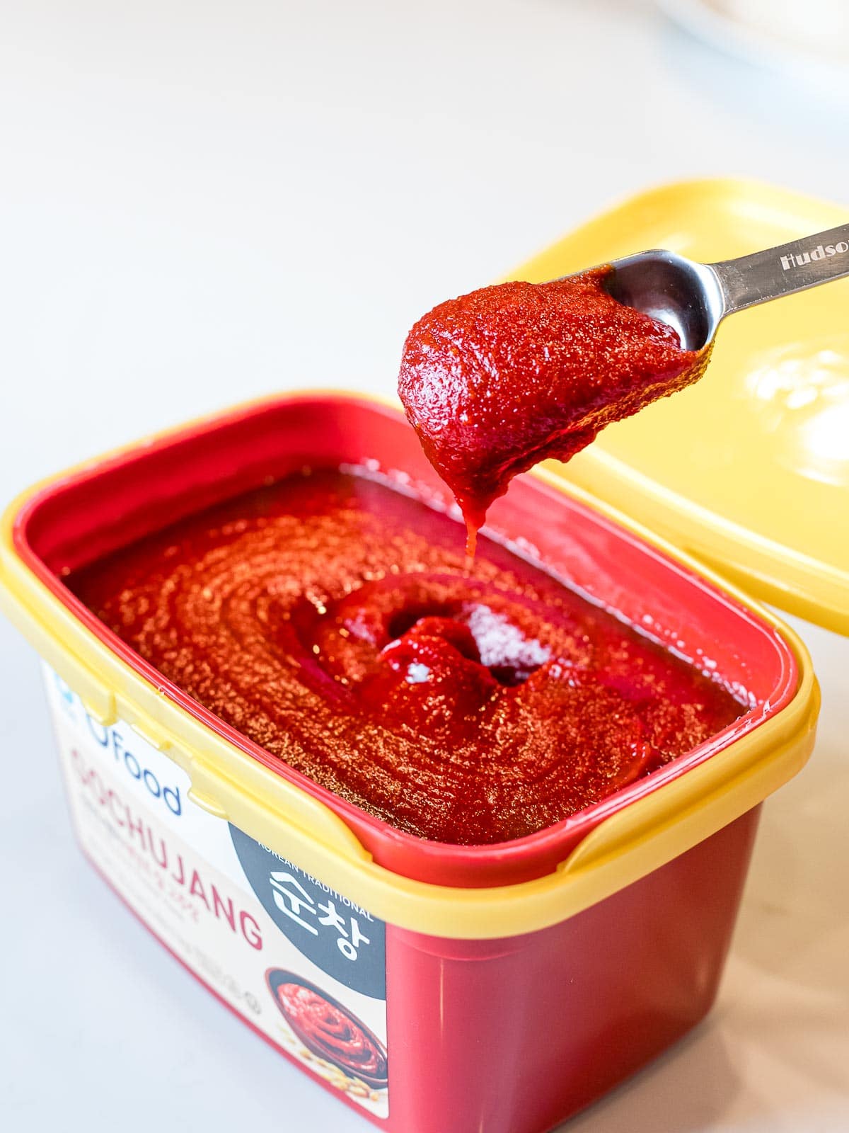 a spoonful of gochujang scooped out of its container