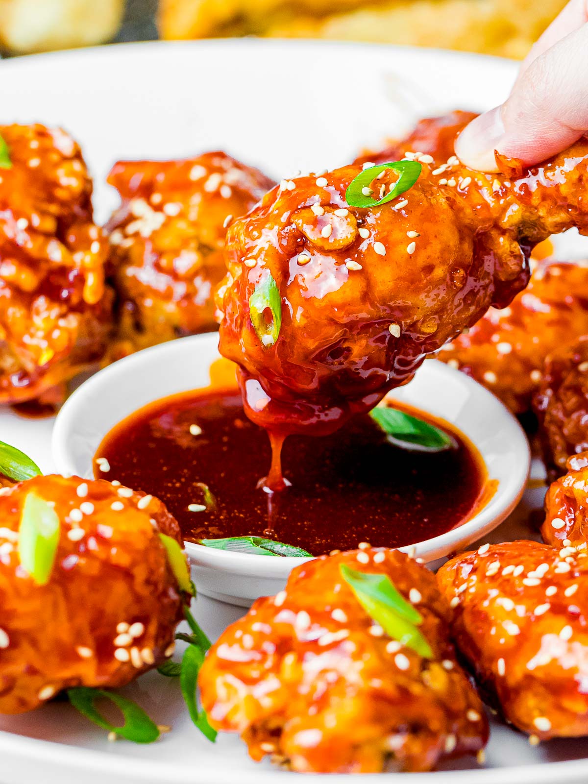 crunchy Korean fried chicken wings dipped into a sweet and spicy gochujang sauce