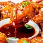 the best Korean fried chicken text with drumstick dipped into a red sauce