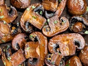 close up of twice cooked mushrooms with garlic butter and chopped parsley