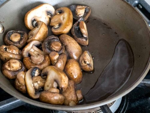 mushrooms releasing liquid after being dry sauteed in a pan