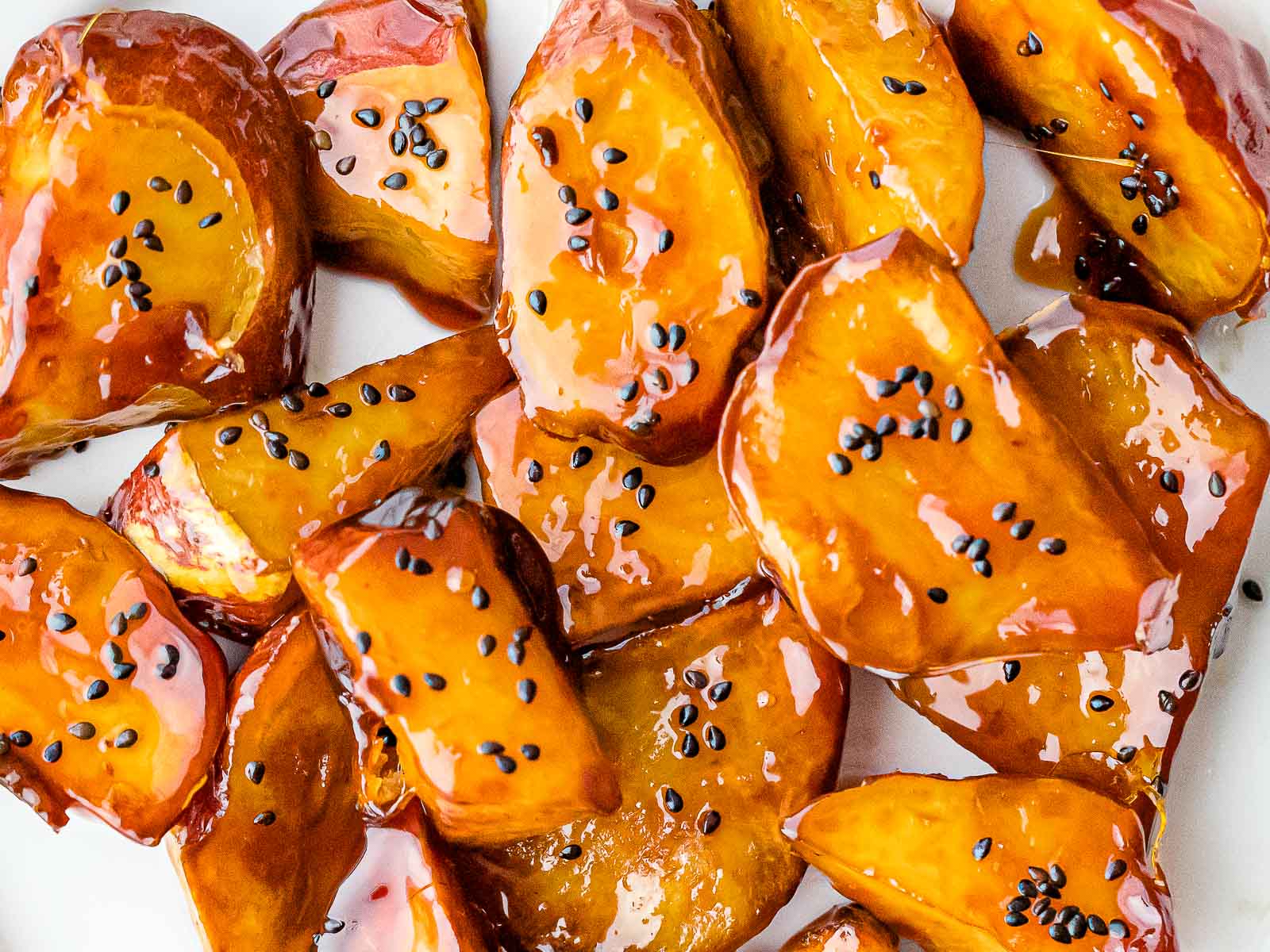 Korean caramelized sweet potatoes garnished with black sesame seeds