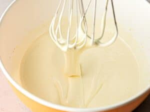 egg yolks beaten to fluffy, pale yellow ribbons falling off whisks