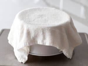 chiffon cake pan turned upside down and covered with a damp towel to cool it down