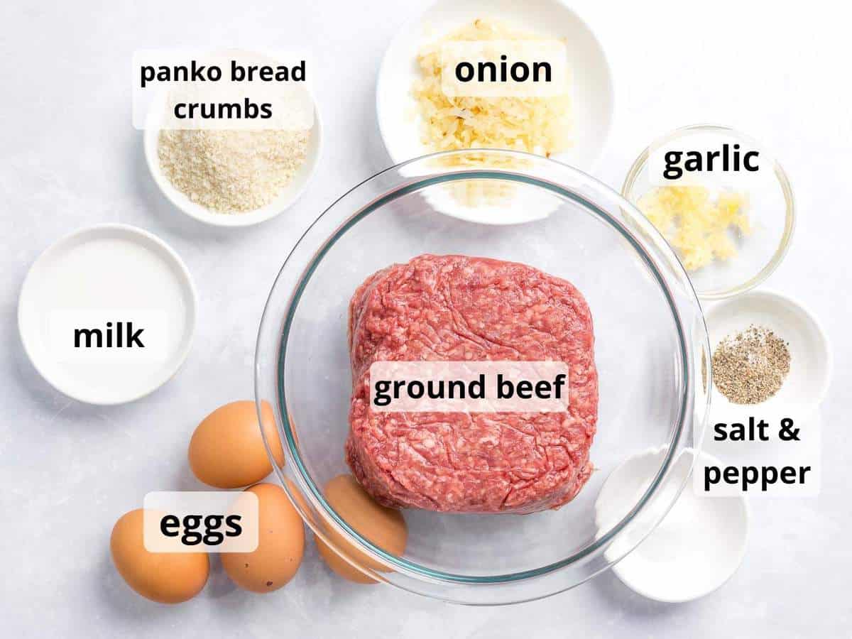 Ingredients for loco moco in glass containers including ground beef, eggs, onions, and seasonings.