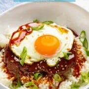 Hawaiian loco moco with fried egg, brown gravy, and burger patty over white rice.