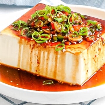 Silken tofu with Korean soy sauce made with green onions, red pepper flakes, sesame seeds poured on top.