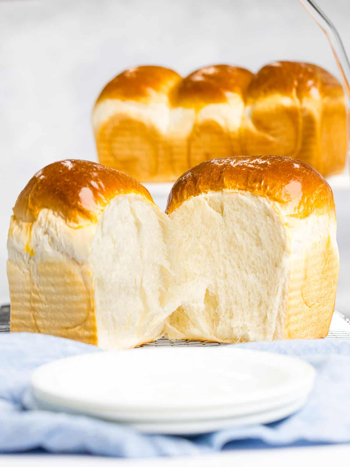 Shokupan or Japanese milk bread pulled apart to reveal soft, fluffy crumb.