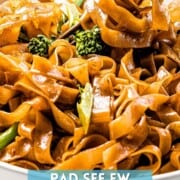 Pad see ew noodles wrapped around chopsticks with text overlay.