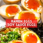 Ramen eggs or soy sauce eggs cut in half to show runny jammy yolk place on top of ramen noodles.