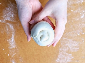 Milk bread dough shaped and rolled into a spiral.