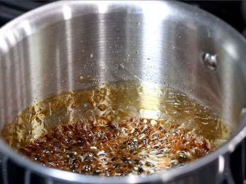 Teriyaki sauce boiling and reducing in a pot.
