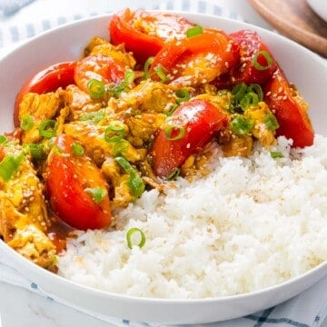 Chinese tomato egg stir fry in a bowl of rice.