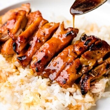 Chicken teriyaki glazed with sauce with steamed rice.