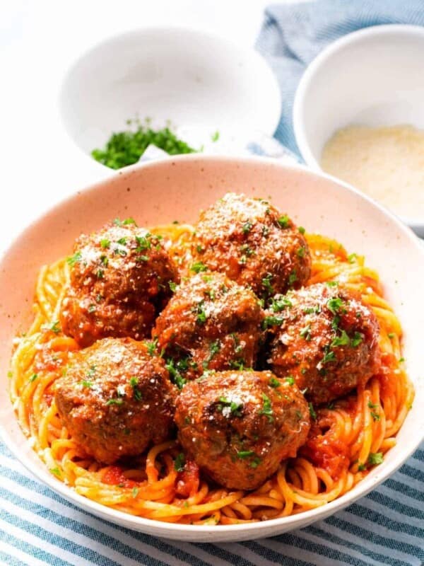 Italian meatballs baked in the oven with tomato sauce and spaghetti.