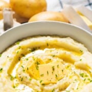 Creamy garlic mashed potatoes with text overlay.