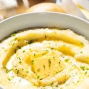 Creamy garlic mashed potatoes with text overlay.