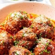 Homemade Italian meatballs with tomato sauce and spaghetti.