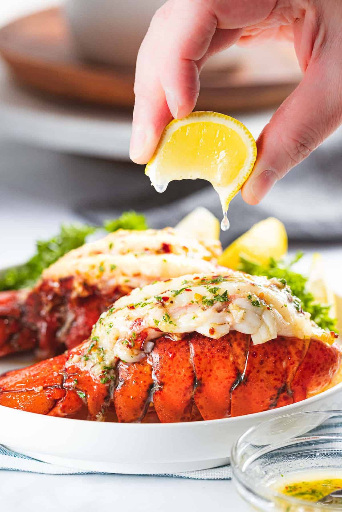Broiled lobster tail with lemon juice squeezed on top.