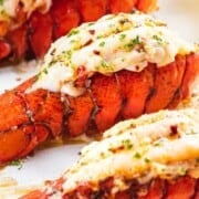 Broiled lobster tail with text overlay.