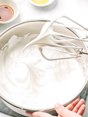 Egg whites whipped to firm peaks on a whisk.