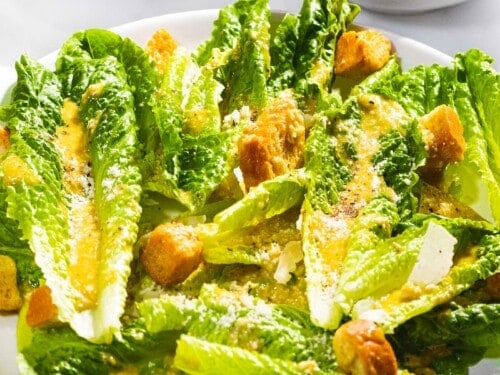 Classic Caesar salad with romaine lettuce, croutons, and dressing from scratch.