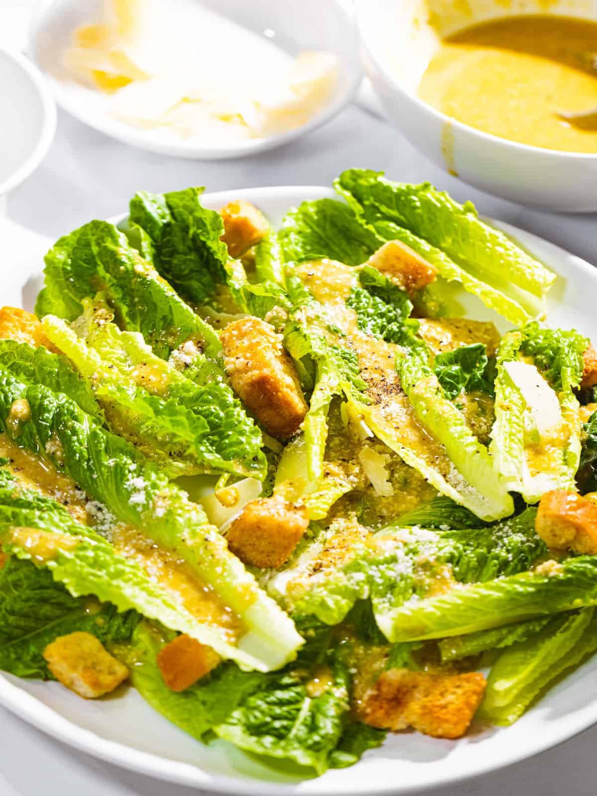 Caesar salad with dressing, romaine lettuce, and croutons.