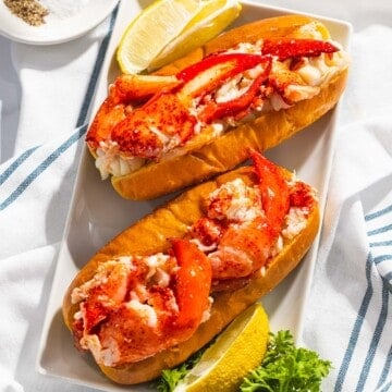 Connecticut lobster rolls or warm lobster rolls on a plate.