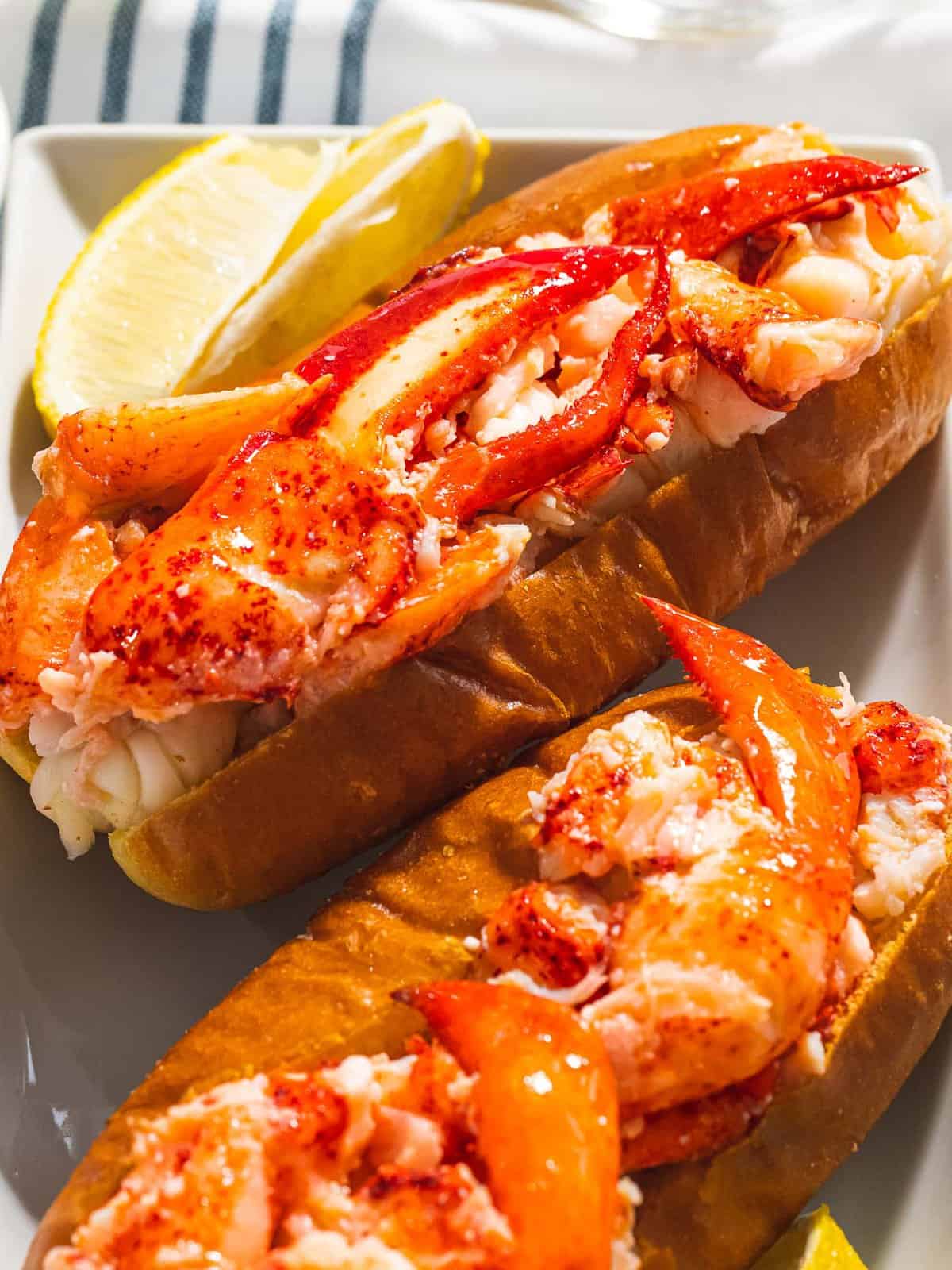Buttered lobster roll with red claw meat on a toasted bun.