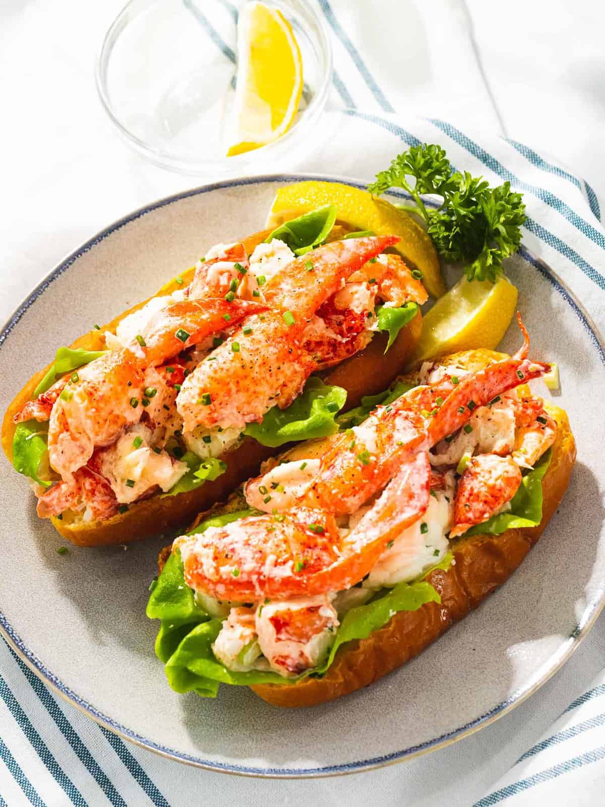 Maine lobster rolls coated in a light mayo dressing with butter lettuce.