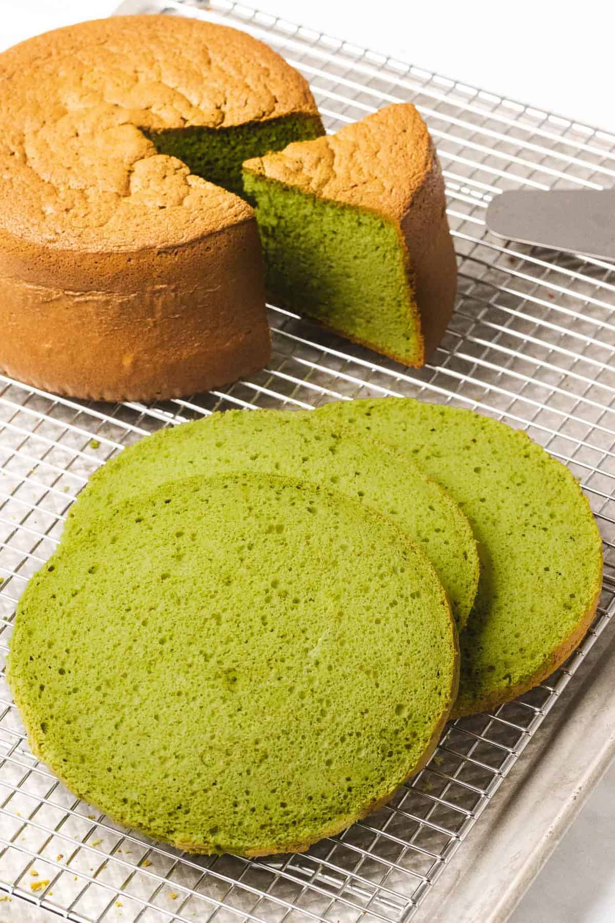 Matcha sponge cake with green interior cut into layers to show soft and fluffy texture.