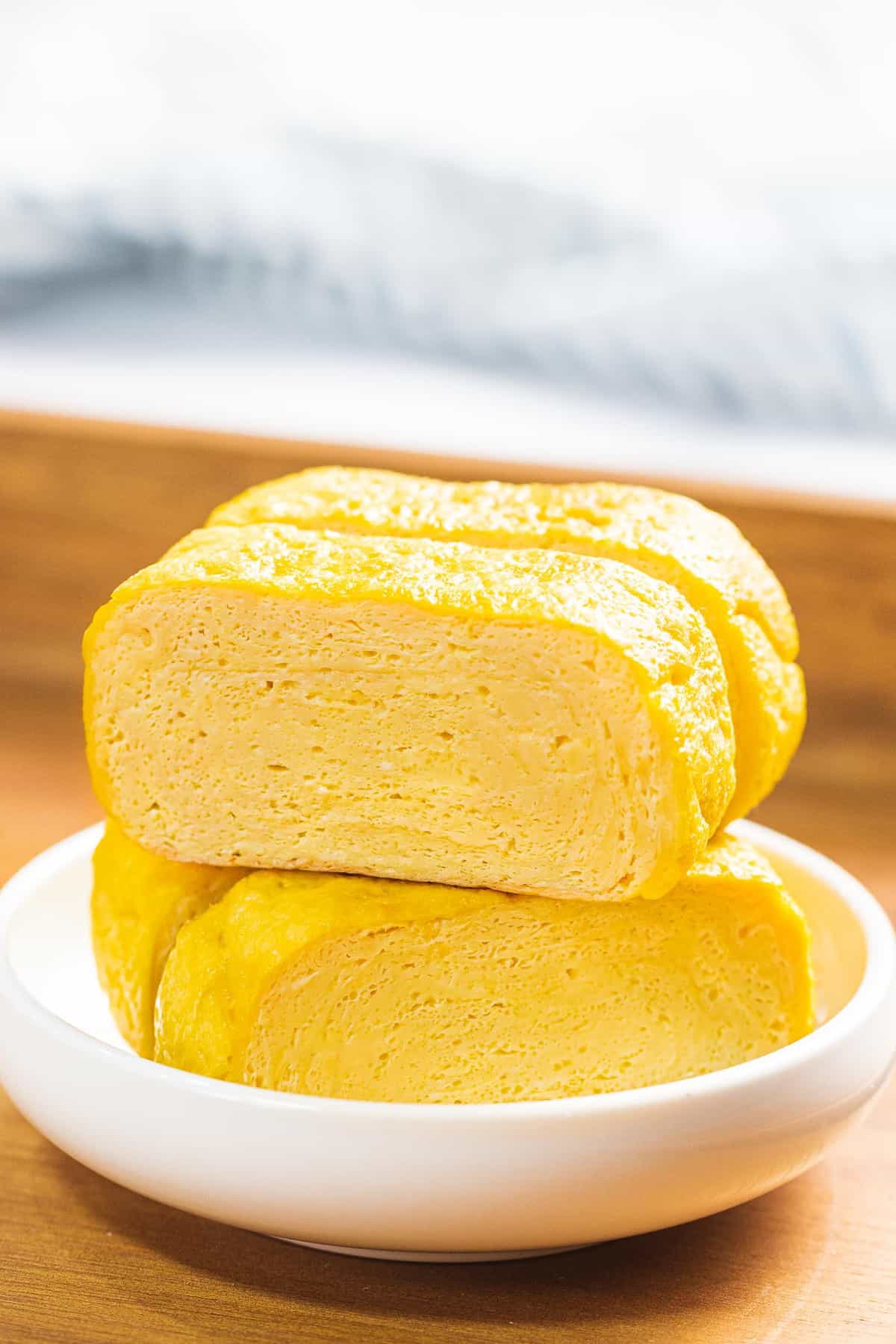 Tamagoyaki or Japanese rolled omelette in a small white bowl.