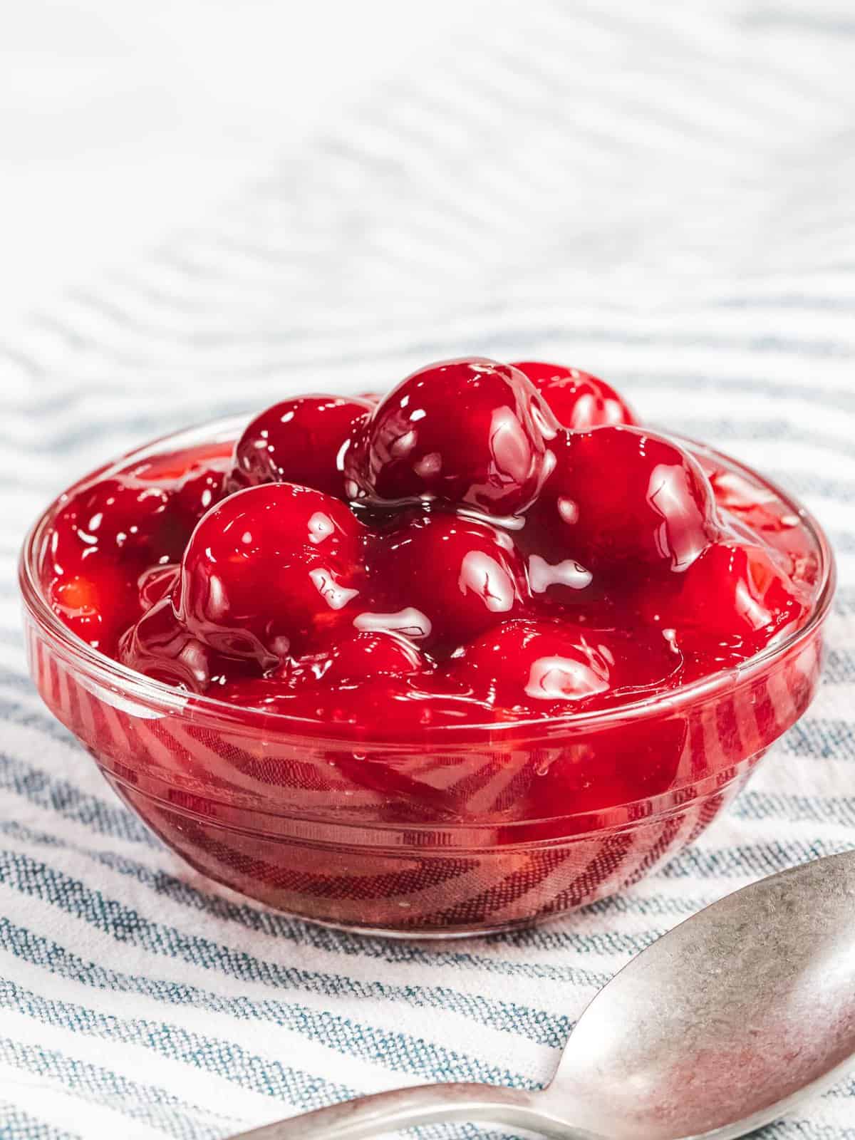 Cherry pie filling in a glass bowl.
