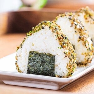 Easy onigiri or Japanese rice balls with nori wrap and furikake.