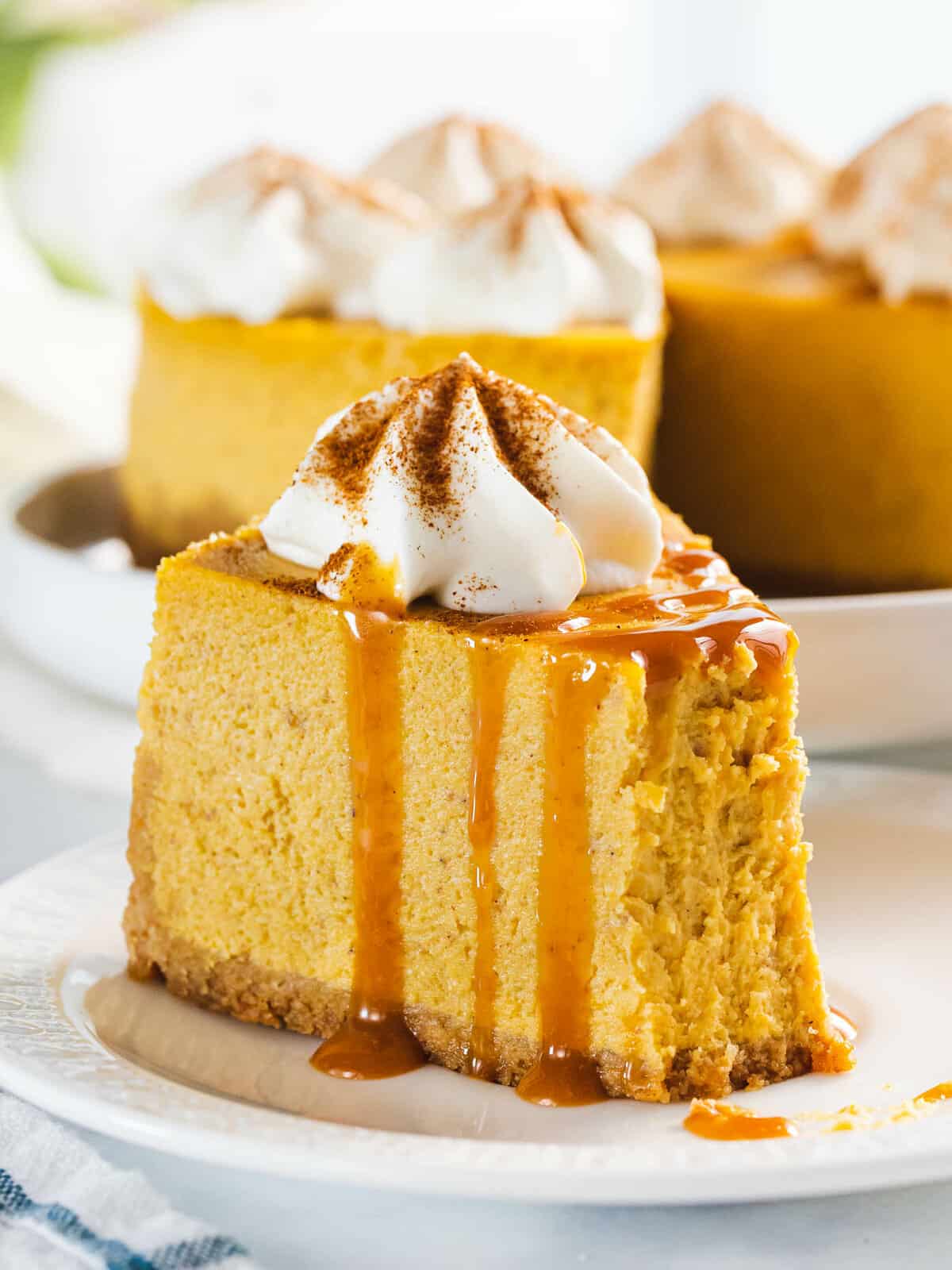 Pumpkin cheesecake with caramel sauce and whipped cream.