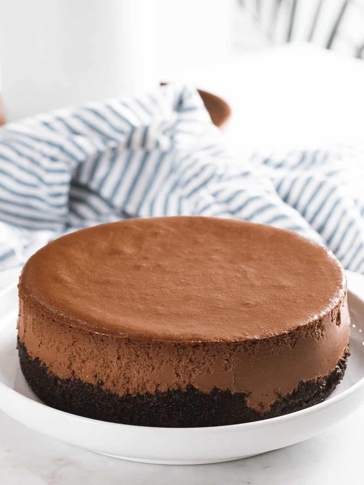 Chocolate cheesecake with chocolate crust on a plate.