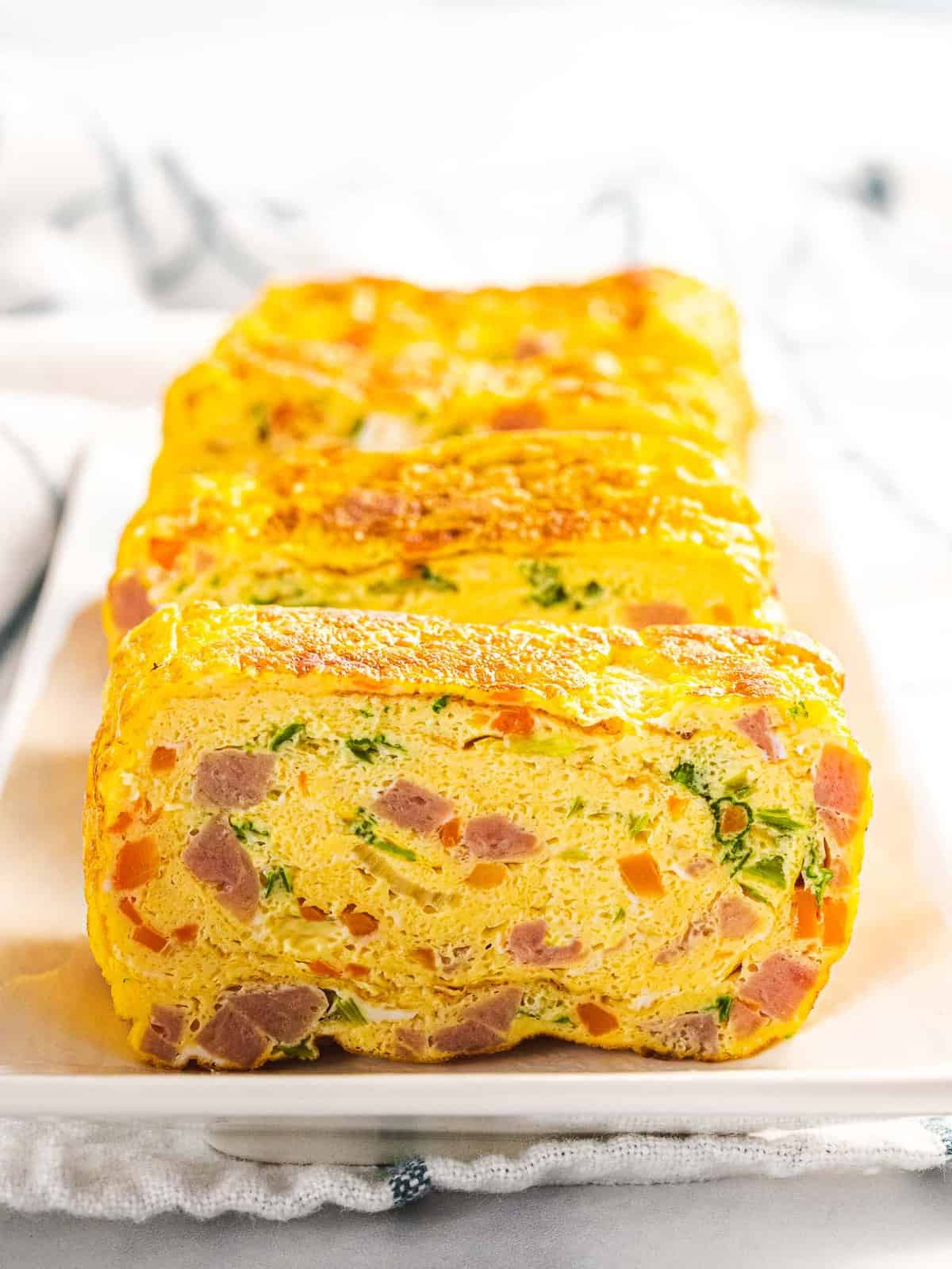 Korean rolled omelet with ham, carrots, and green onions.