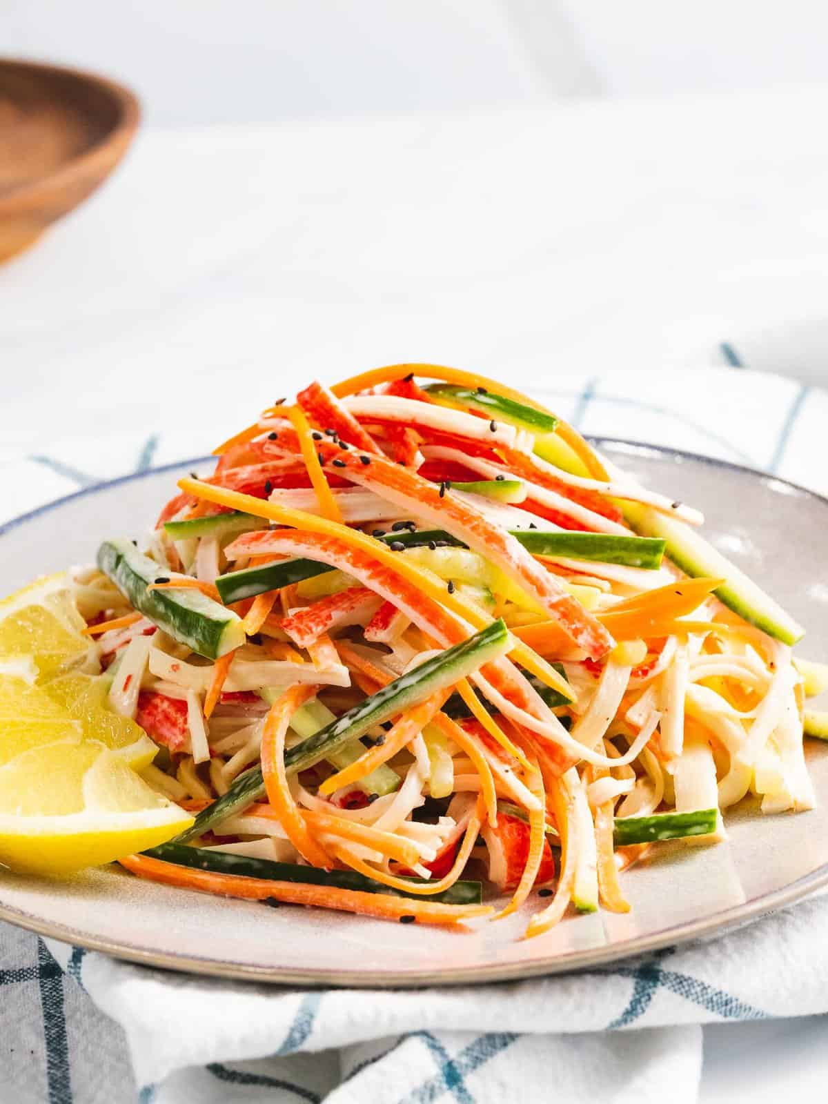Kani salad made with crab stick, carrots, and cucumbers dressed in a mayo dressing.
