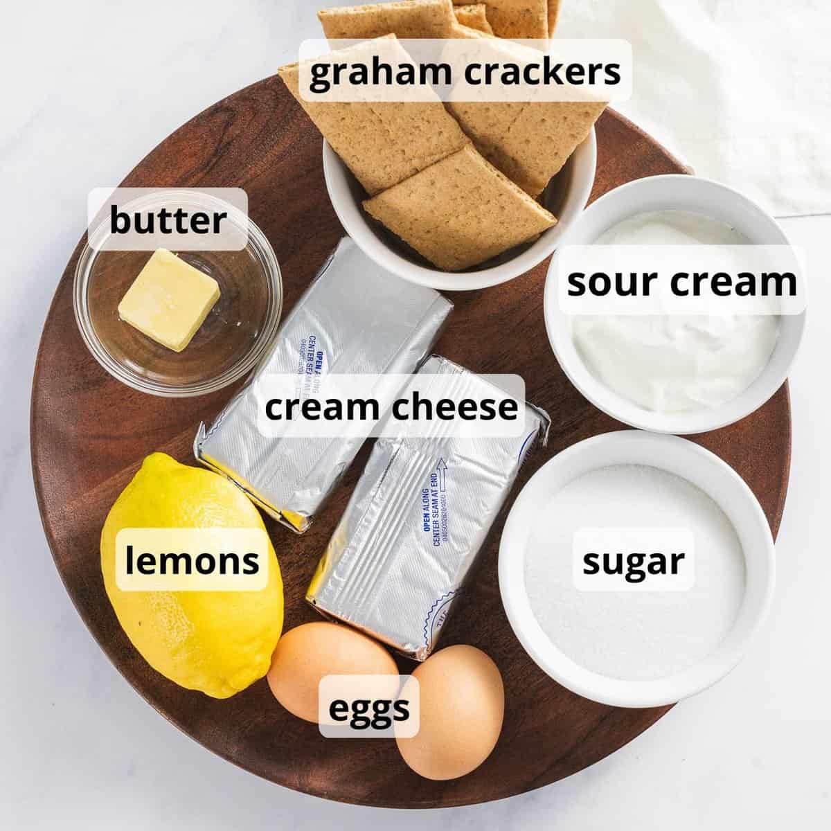 Ingredients for lemon cheesecake with text.