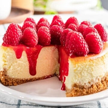 Raspberry cheesecake with fresh raspberry topping and raspberry sauce..