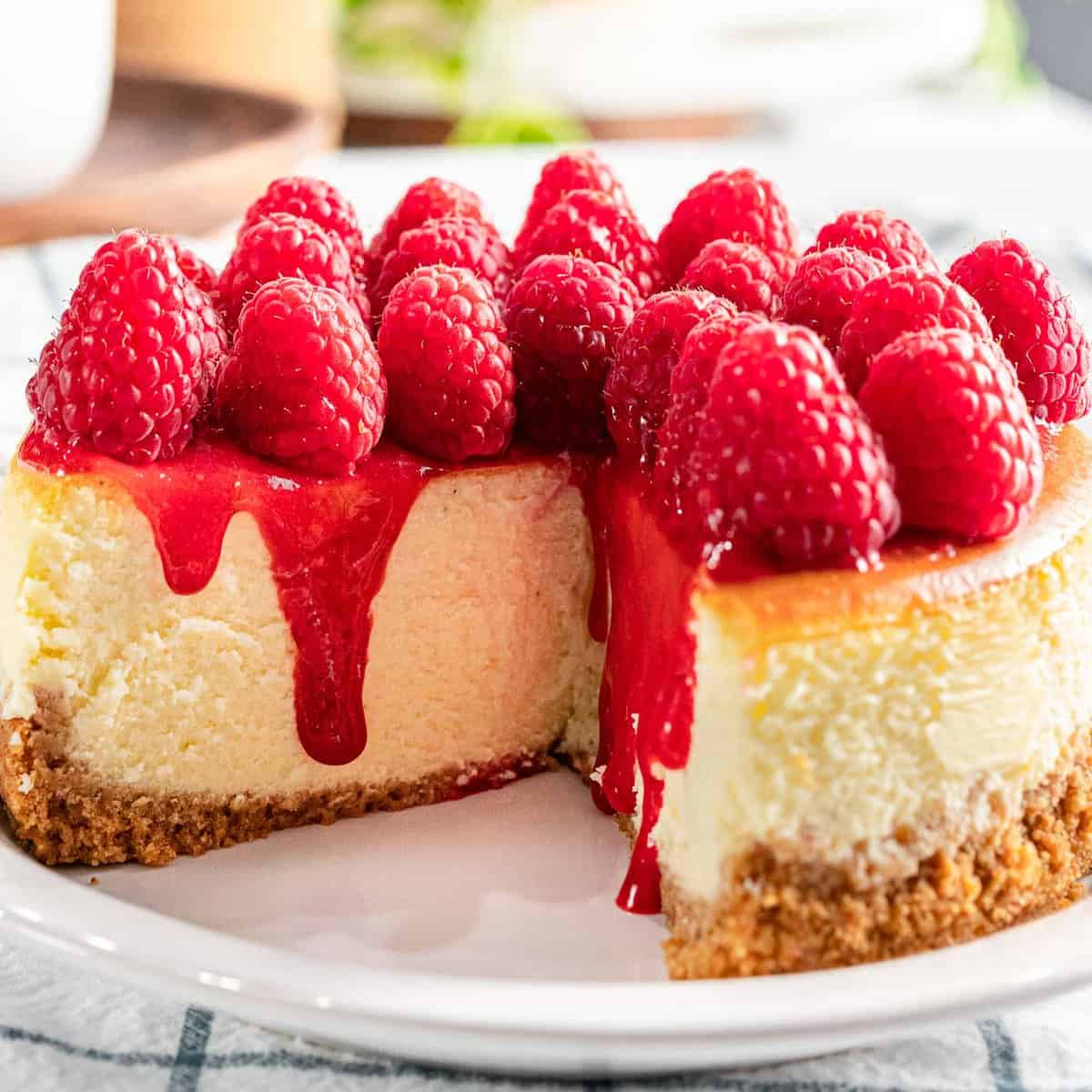 Raspberry cheesecake with fresh raspberry topping and raspberry sauce.