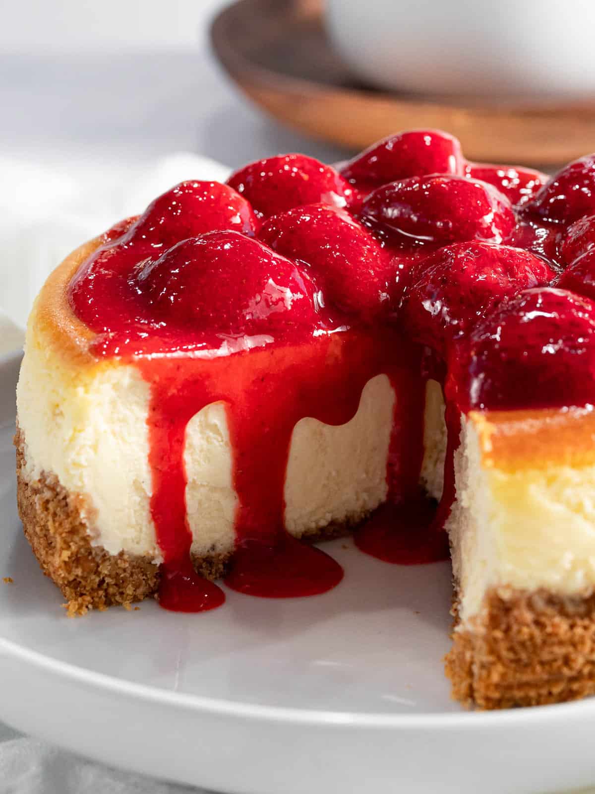 Strawberry sauce is used to glaze the top of cheesecake.