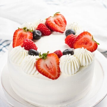 Chantilly cake decorated with fresh berries and mascarpone Chantilly cream.