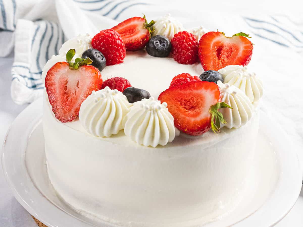 Fluffy Chantilla cake decorated with berries and mascarpone whipped cream.